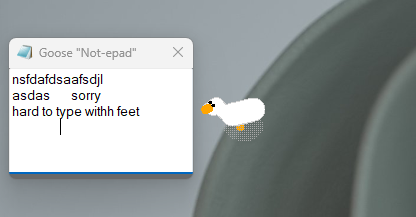 Oca virtuale di Desktop Goose che cammina sul desktop di Windows portando un cartello